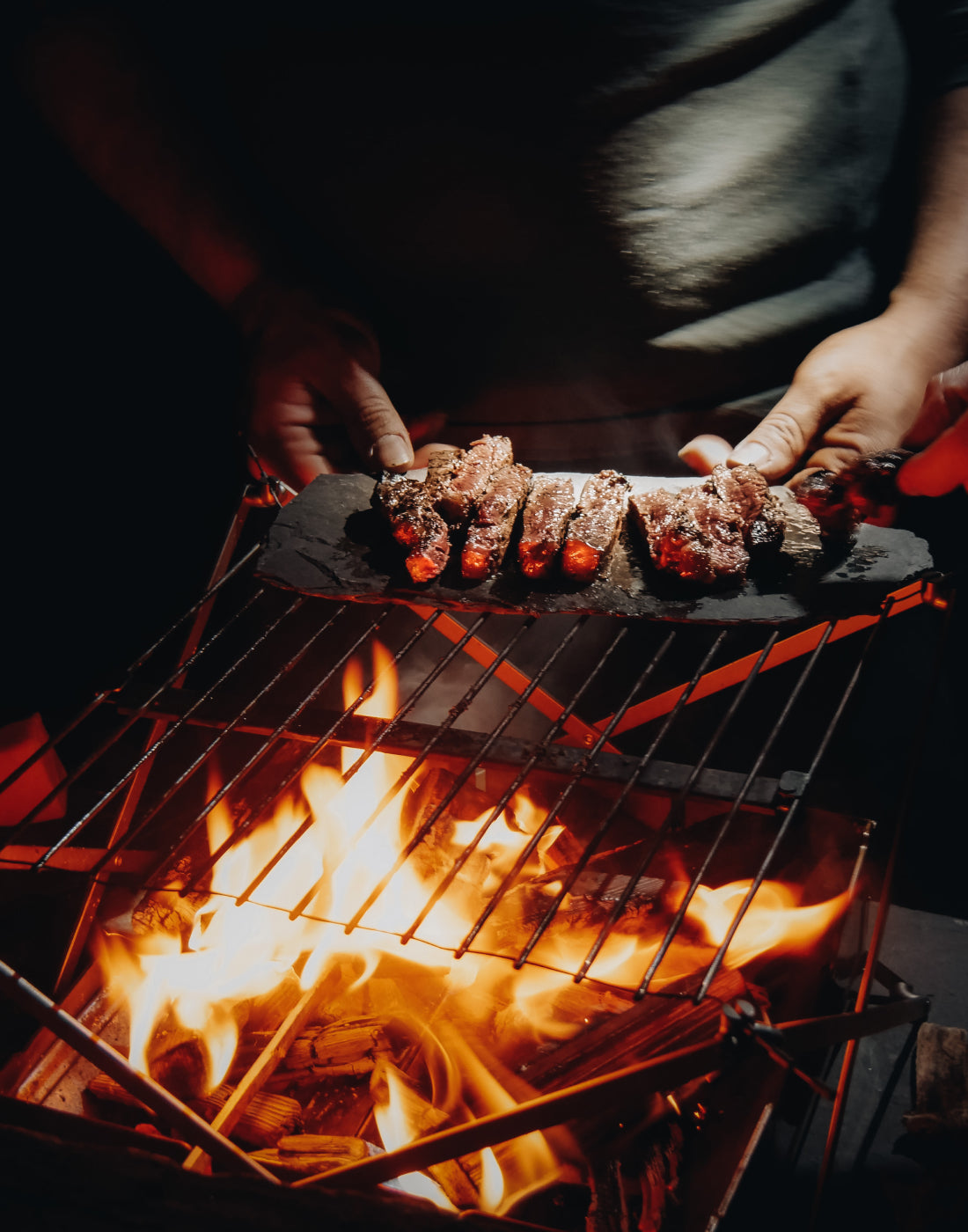 Grill inferno, Black backdrop with a blazing fire on the barbecue Vertical  Mobile Wallpaper AI Generated 30315900 Stock Photo at Vecteezy